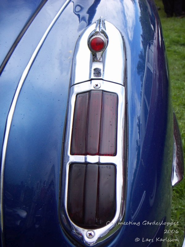 Tail light on a deep blue car, nice design with chromed parts